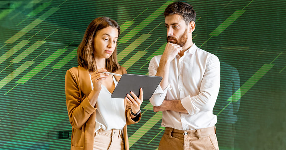 Two people standing and looking at a tablet, with a digital graphical background.