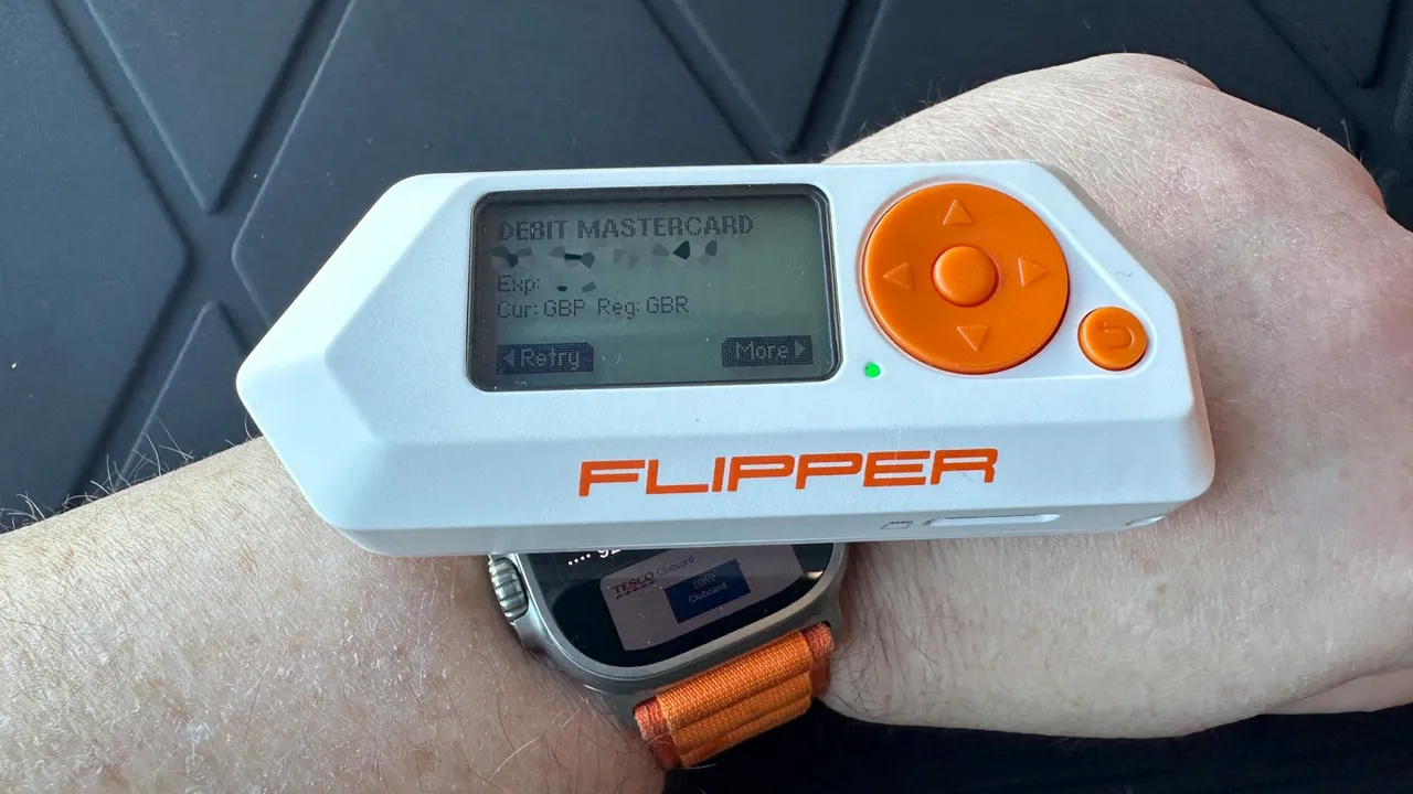 Flipper Zero worn on wrist with readout saying Debit Mastercard